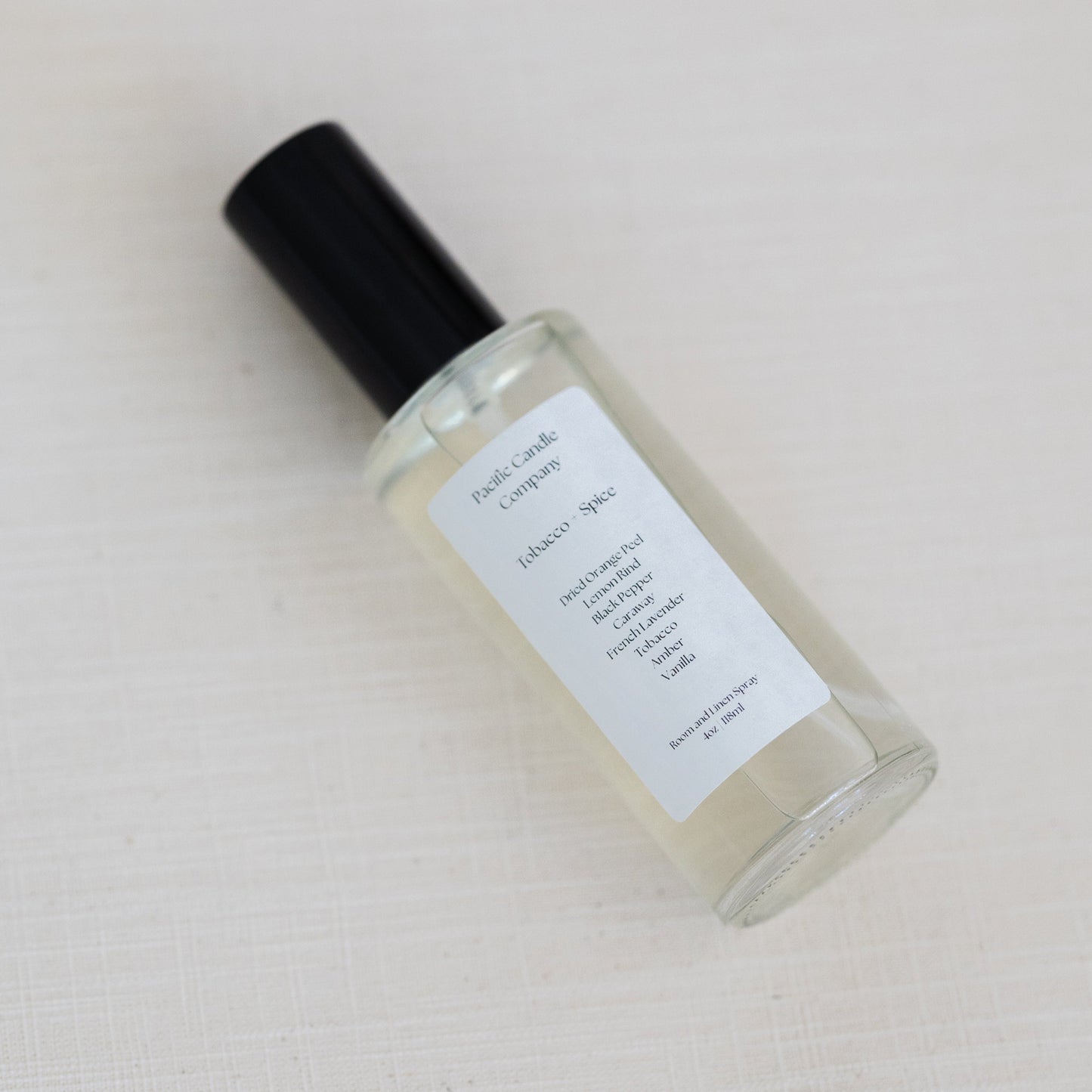 An eco-friendly room spray in a sleek glass bottle, made with clean, phthalate-free ingredients to refresh any space with a luxurious scent. Perfect for quickly creating a calming or uplifting atmosphere. Scent: Tobacco + Spice