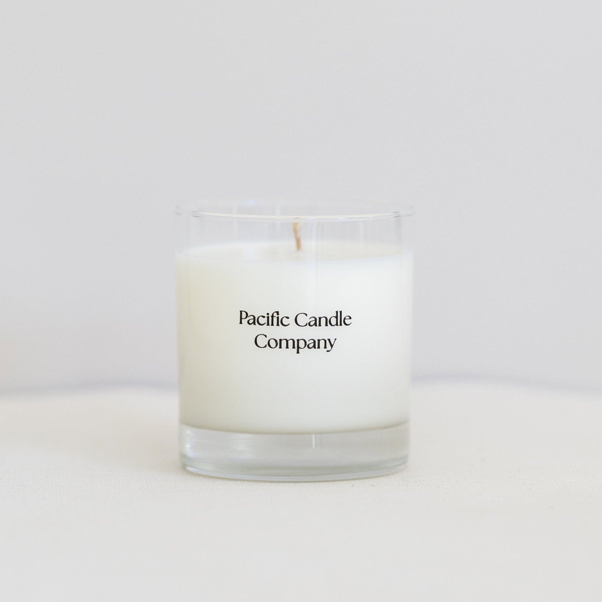 A single wick soy candle in a sleek glass jar, hand-poured with toxin-free wax and a cotton braided wick for a clean, even burn. Perfect for adding a warm glow and a subtle fragrance to any room. 